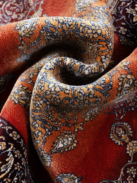 Classic Floral Medallion Rug in Brown, machine-woven herbal-silk rug — rug softly draped and folded to show its silk-like sheen and drape